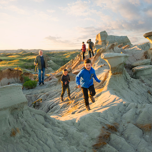 A family hikes through Theodore Roosevelt National Park in North Dakota