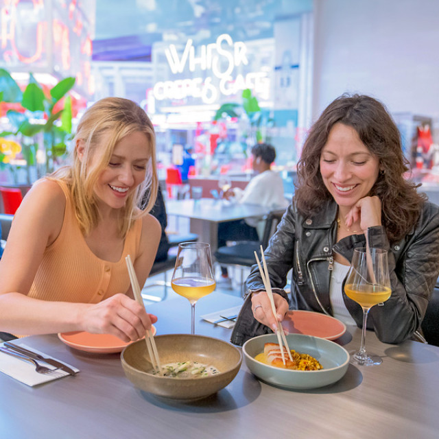Sharing a meal at the POST Houston food hall in Houston, Texas